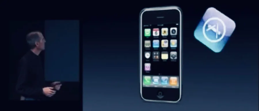 Steve Jobs on stage beside a projected iPhone and the App Store icon
